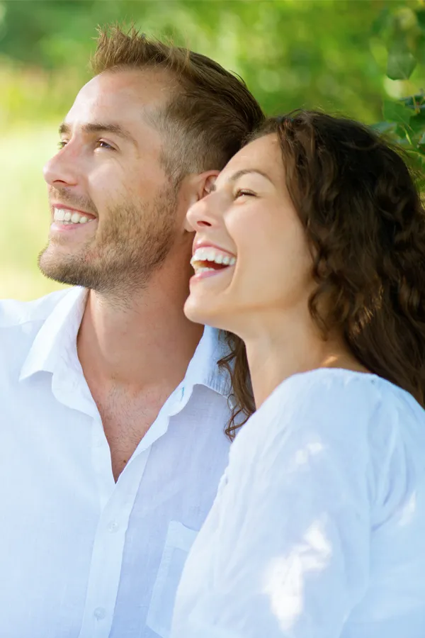 A couple smiles outside lit by the sunset. Get immunotherapy for autoimmune diseases from Allen Green, M.D. of Center for Optimum Health in Los Angeles.