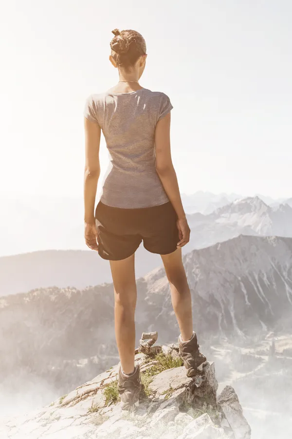 A woman stands on a mountaintop looking out at the horizon. Get LDI allergen injection therapy from Allen Green, M.D. of Center for Optimum Health in Los Angeles.