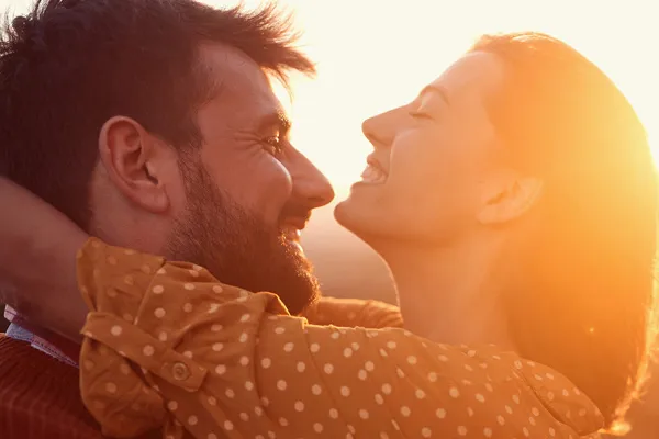 A man and woman embracing in the light of the sunset. Get ozone IV therapy from Allen Green, M.D. of Center for Optimum Health in Los Angeles.