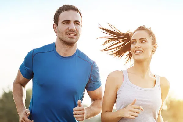 Weight-Loss-Resistance-Doctor A couple happily jogging in the sunlight after receiving effective weight loss resistance care from Allen Green, M.D. of Center for Optimum Health in Los Angeles.